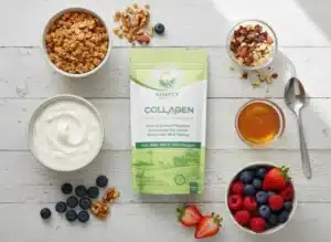 A top-down shot of a rustic white wooden surface displaying the ingredients for a Greek yogurt collagen parfait. At the center, a vibrant green and white "Simply Halal Collagen" product bag is prominently featured, making it the hero of the image. Surrounding the bag are various ingredients in small bowls: a bowl of creamy white Greek yogurt, a bowl of golden granola, a bowl of mixed berries (blueberries, raspberries, and sliced strawberries), and a bowl of chopped nuts. A small glass bowl of honey and a silver spoon are also visible. Loose blueberries, walnuts, and almonds are scattered artistically around the bowls, creating an organized yet natural feel. This arrangement highlights the ease of preparing a nutritious meal and showcases the benefits of collagen in Greek yogurt.